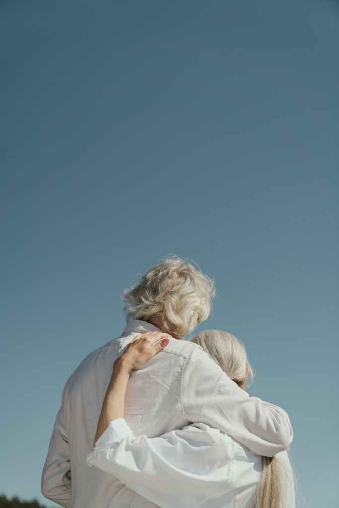 an elderly couple hugging
