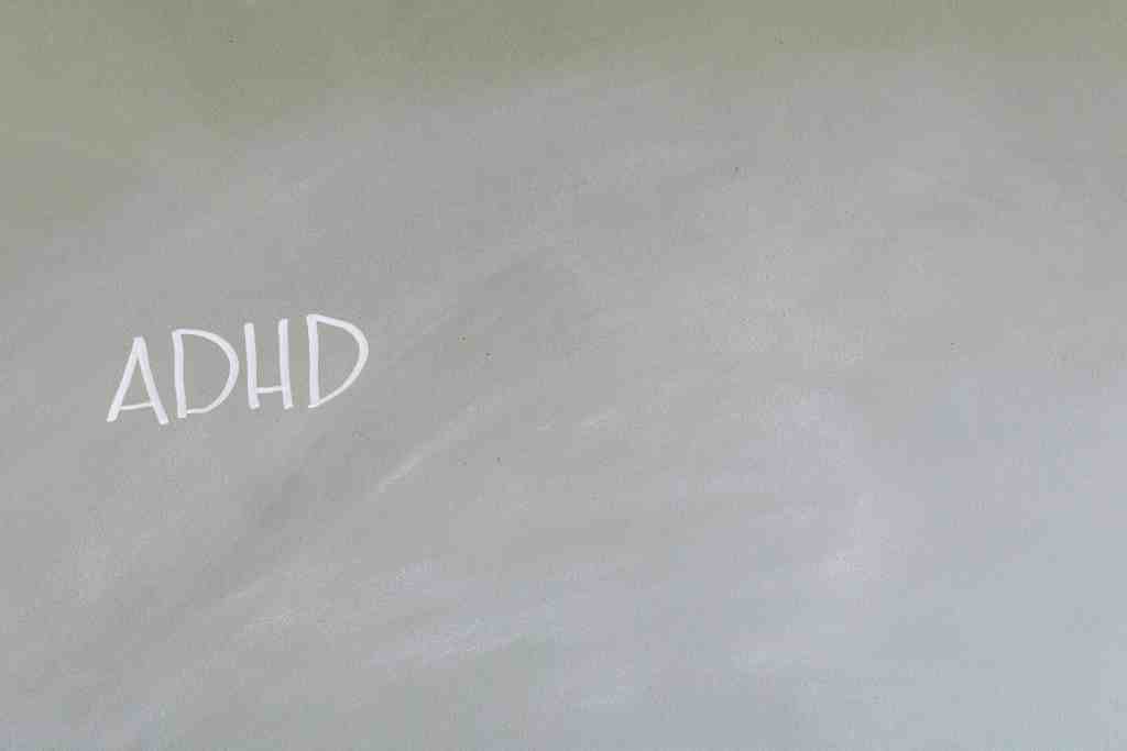 ADHD written on a green wall, representing mental health awareness and neurodiversity.