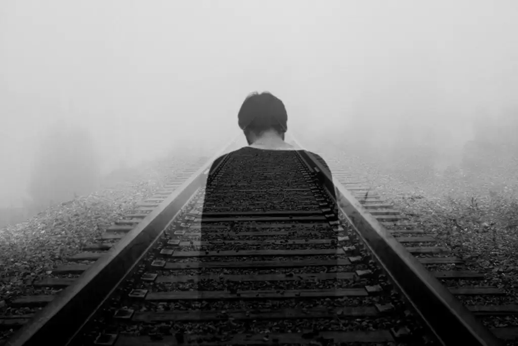 a person standing on train tracks