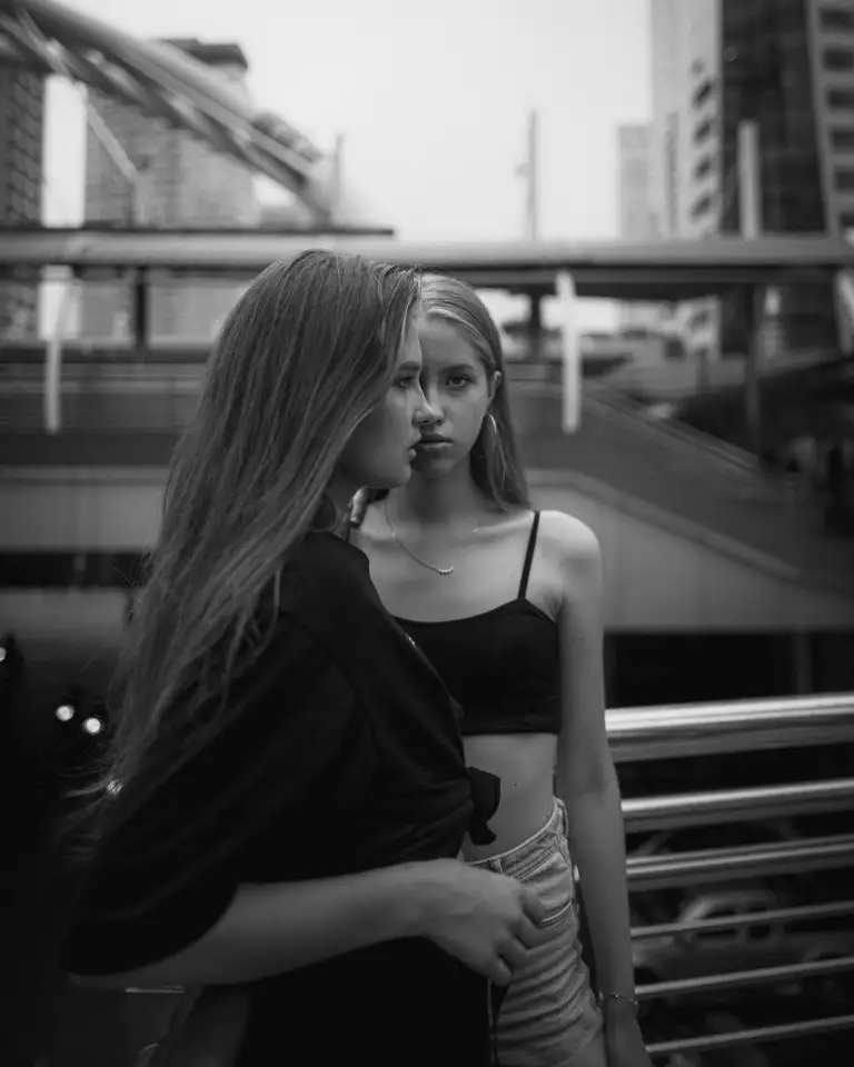 a girl passing through another girl